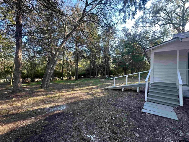 a backyard of a house with lots of green space