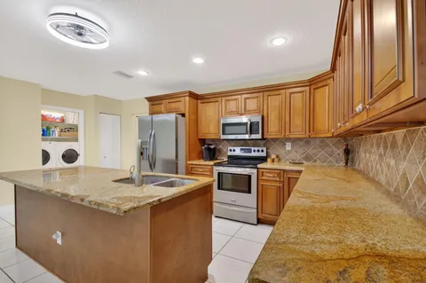 a kitchen with a cabinets and white stove