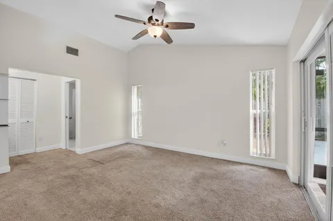 a bedroom with a large bed and a glass door