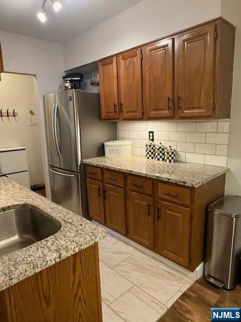 458 River, Unit C Nutley, NJ 07110 - Photo 8 of 15 a kitchen with stainless steel appliances granite countertop a sink refrigerator and cabinets