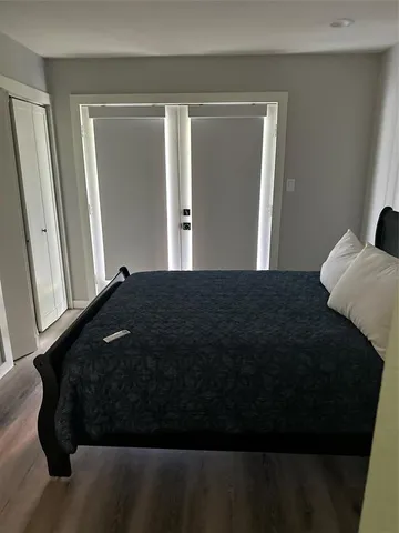 a bed room with a bed and a mirror