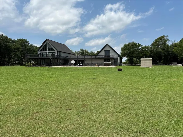 a view of backyard with wooden fence