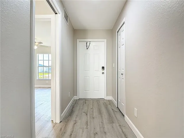 a view of hallway with wooden floor