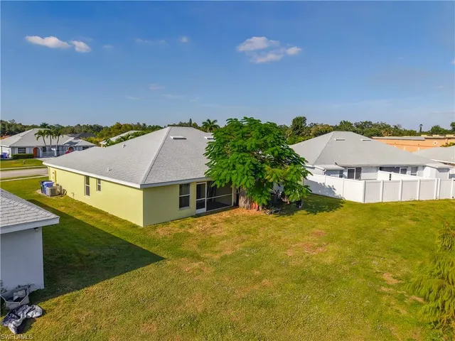 a view of a house with a yard and sitting area