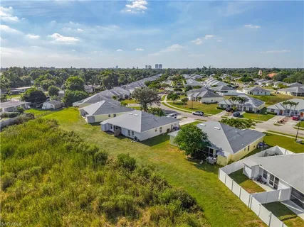 an aerial view of residential houses with outdoor space and swimming pool