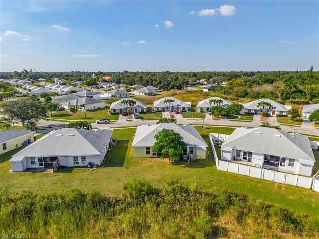 an aerial view of residential houses with outdoor space and swimming pool