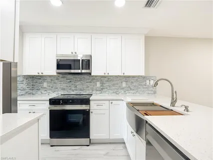 a kitchen with a stove and a sink