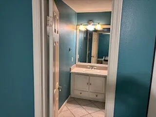 a bathroom with a sink and mirror