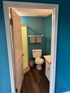 a white toilet sitting next to a bathroom sink