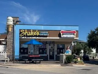 a big house with a big yard and large trees