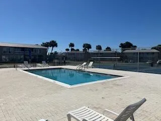 a view of a swimming pool with a lounge chair