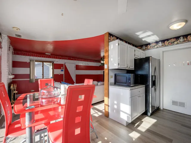 a kitchen with stainless steel appliances kitchen island granite countertop a refrigerator and a stove top oven