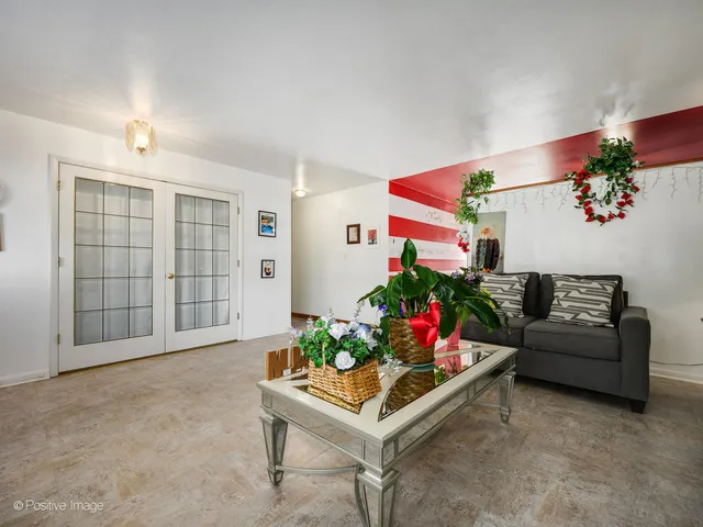 a living room with furniture and flowers