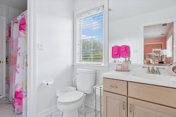 a bathroom with a sink vanity mirror and toilet