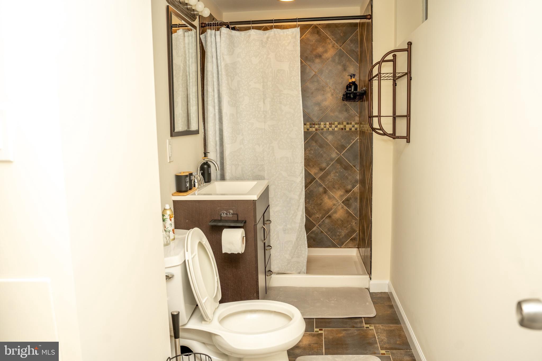 924 Veirs Mill Road Rockville, MD 20851 - Photo 11 of 12 a bathroom with a sink toilet and shower