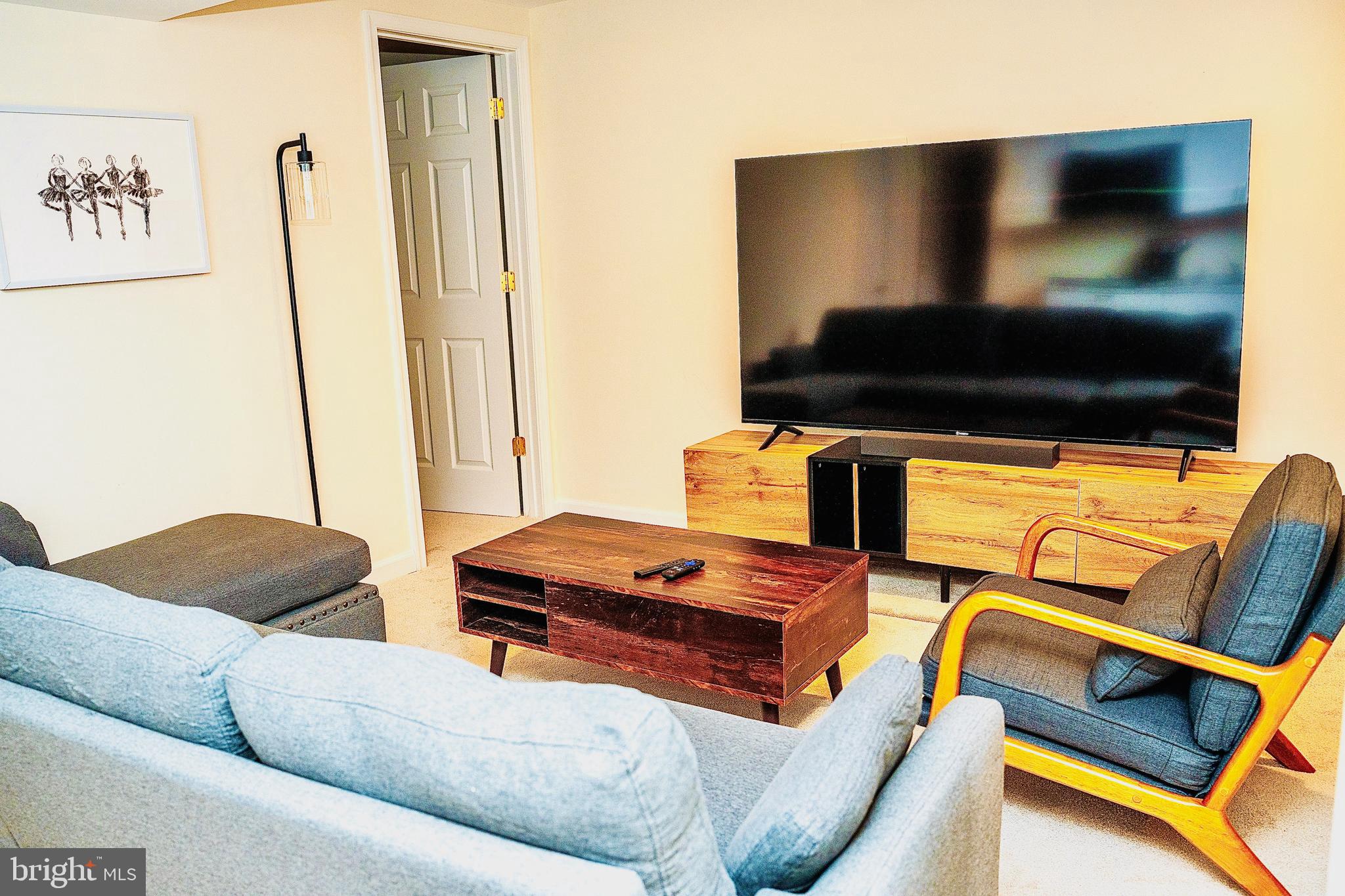 924 Veirs Mill Road Rockville, MD 20851 - Photo 4 of 12 a living room with furniture and a flat screen tv