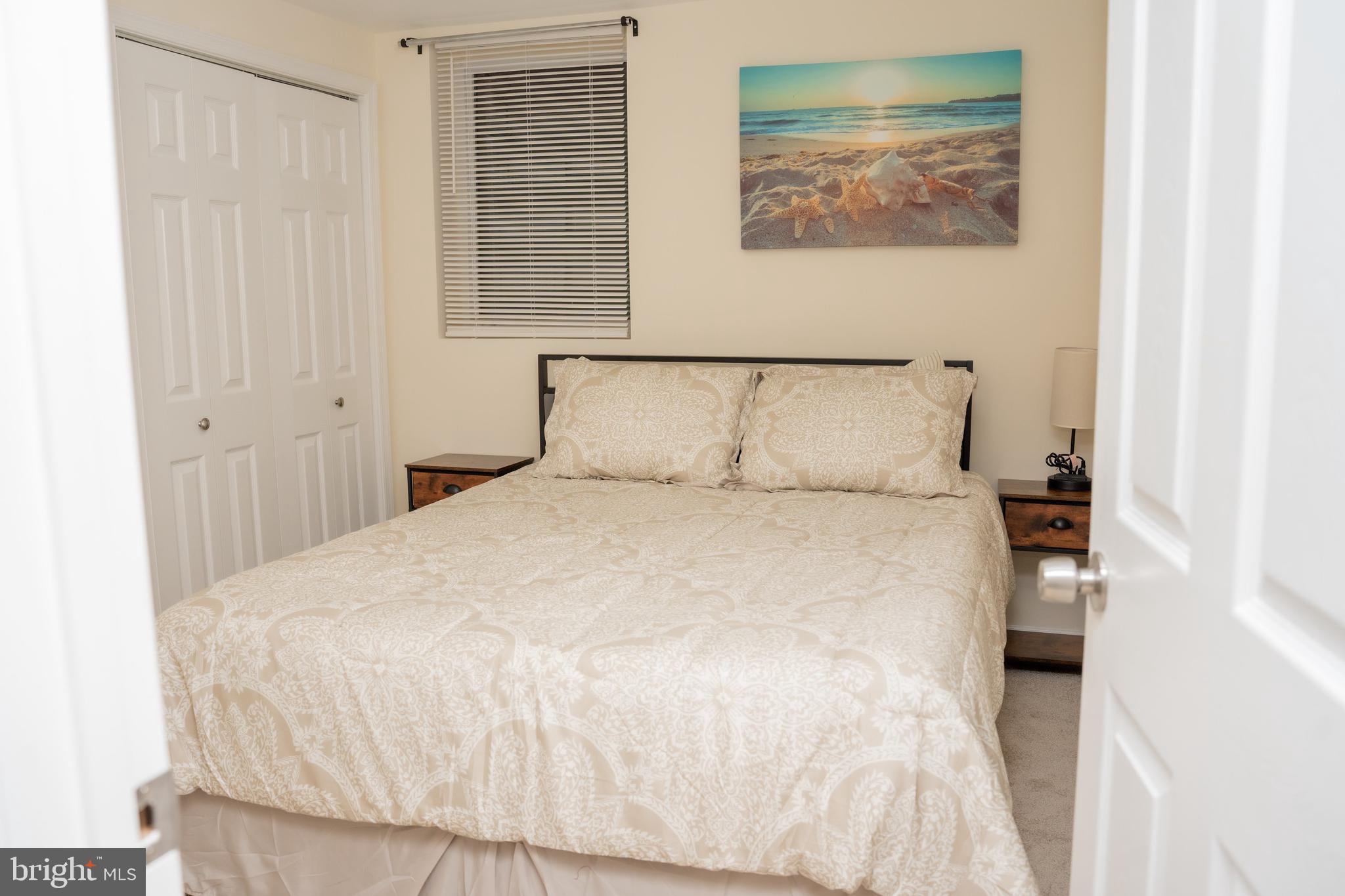 924 Veirs Mill Road Rockville, MD 20851 - Photo 8 of 12 a large bed sitting in a bedroom next to a window