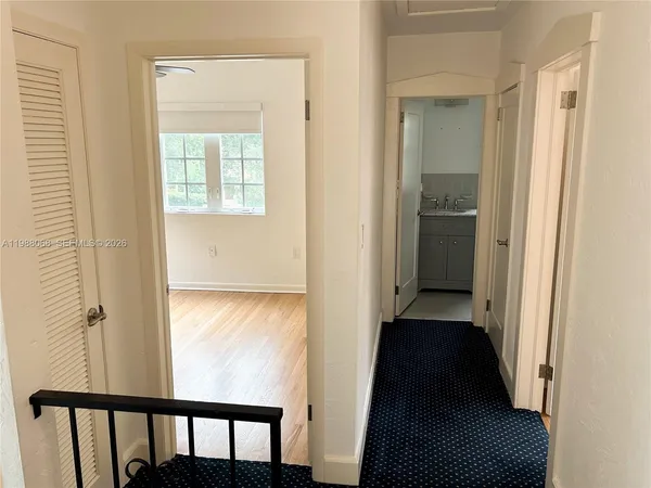 a view of entryway and hall with wooden floor