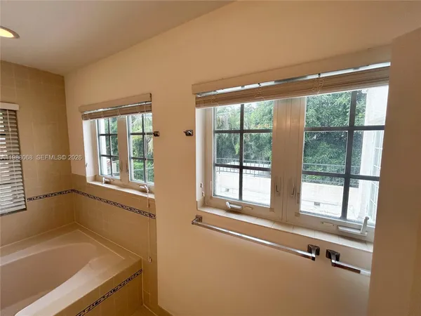 an empty room with wooden floor and entrance