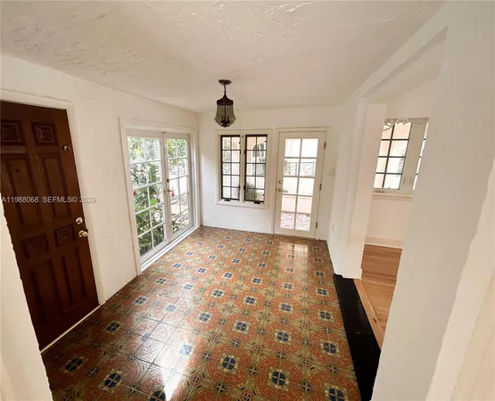 a view of hallway with windows and wooden floor