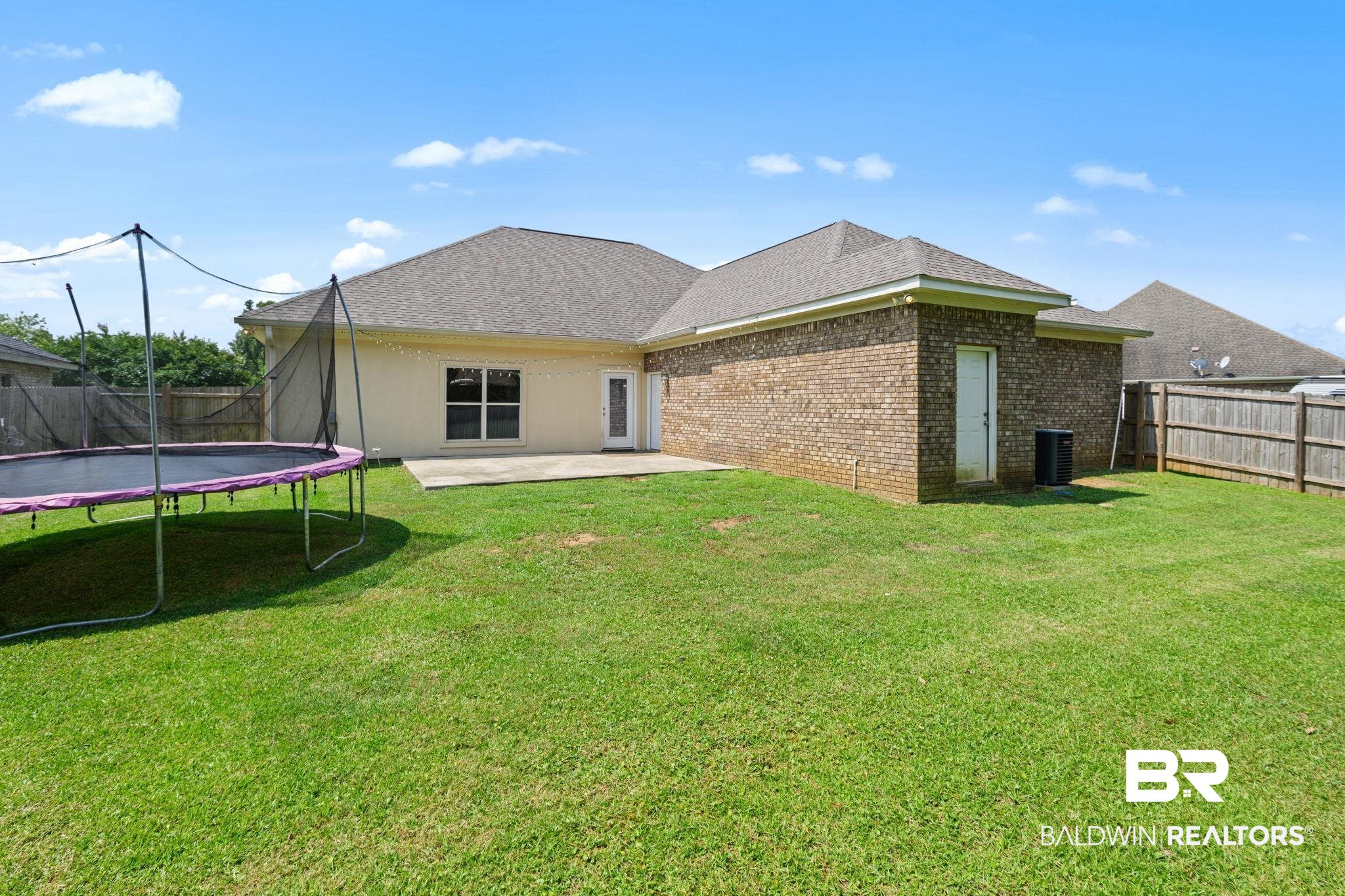 9730 Harmony Ridge Circle West Semmes, AL 36575 - Photo 35 of 38 Back of house with a trampoline, a patio area, central AC unit, brick siding, and roof with shingles