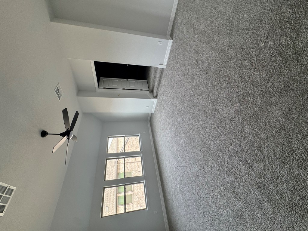 232 Camille Street Leander, TX 78641 - Photo 11 of 26 an empty room with windows and ceiling fan