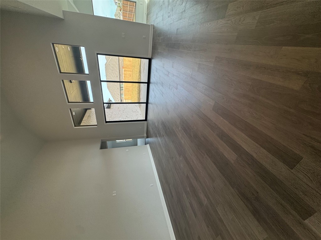 232 Camille Street Leander, TX 78641 - Photo 5 of 26 a view of empty room with wooden floor and fan