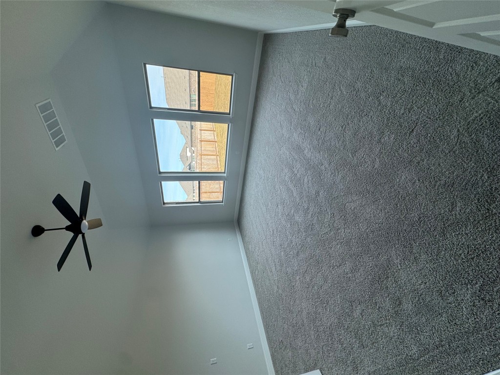 232 Camille Street Leander, TX 78641 - Photo 8 of 26 an empty room with windows and fan