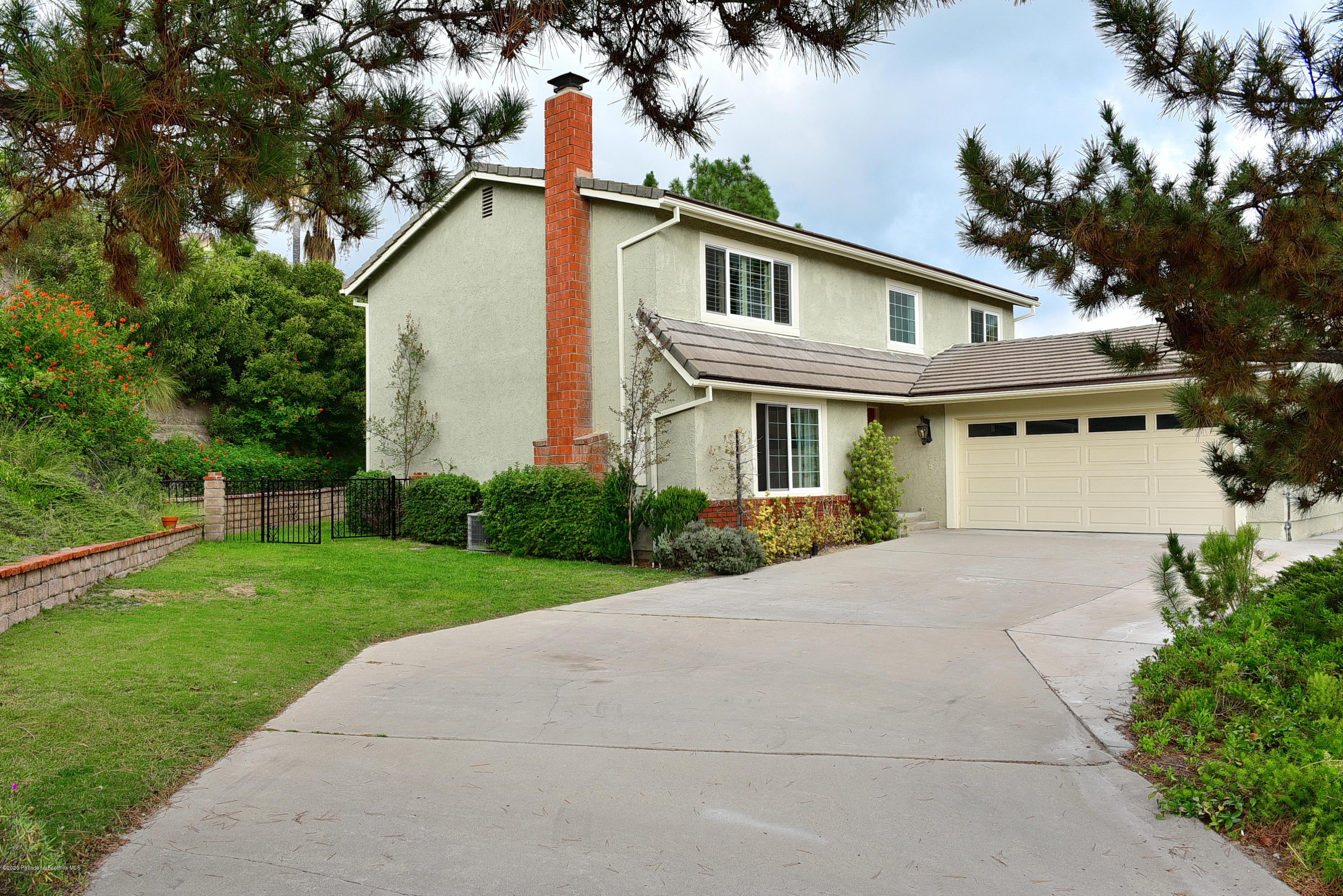 3107 Chadney Drive Glendale, CA 91206 - Photo 2 of 26 a front view of a house with a yard and potted plants
