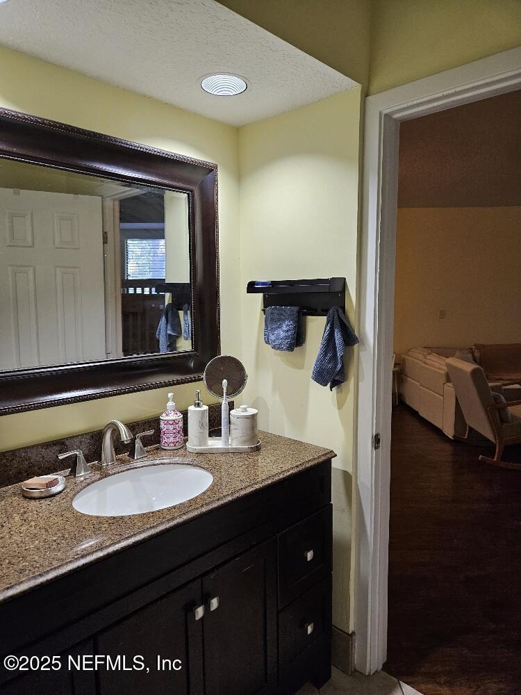 2970 Ravines Road, Unit 1326 Middleburg, FL 32068 - Photo 4 of 7 a bathroom with a granite countertop sink and a mirror