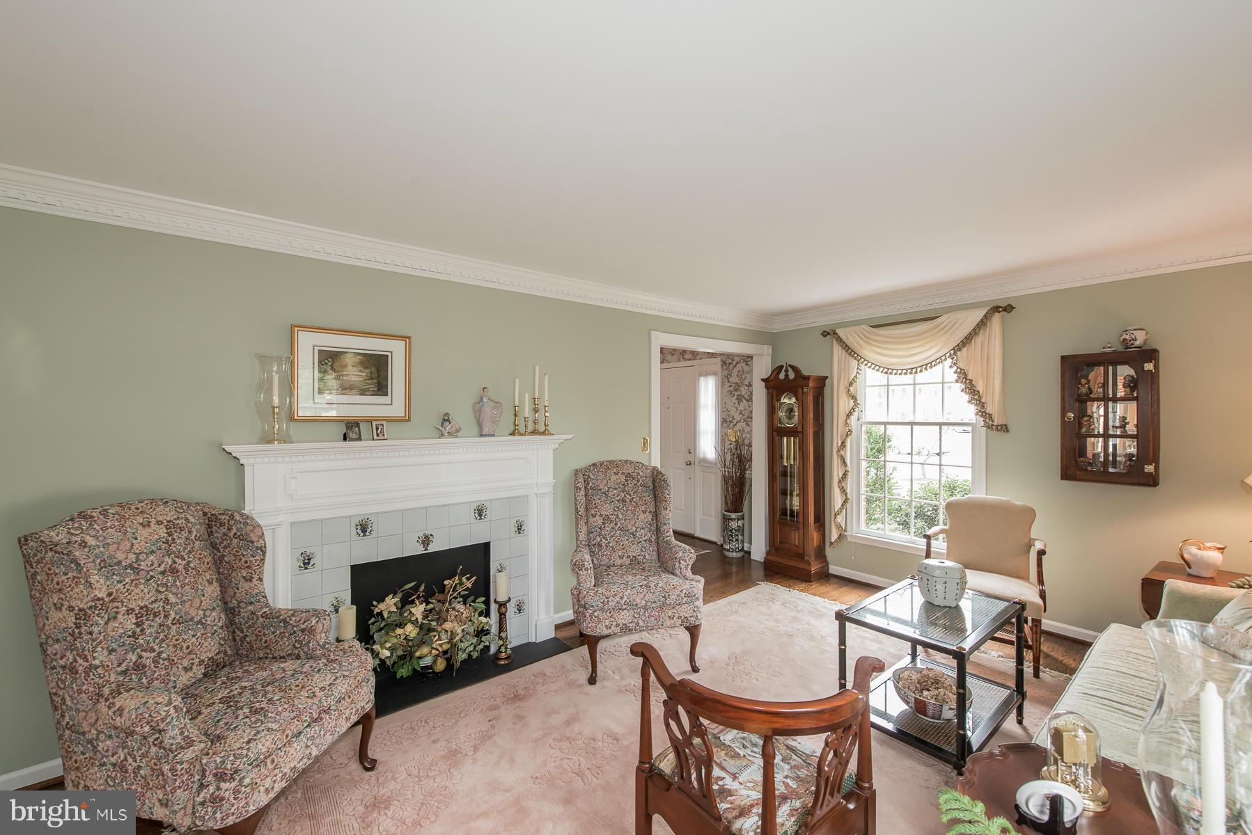 3677 Meadowvale Road Ellicott City, MD 21042 - Photo 2 of 30 a living room with furniture a fireplace and a window