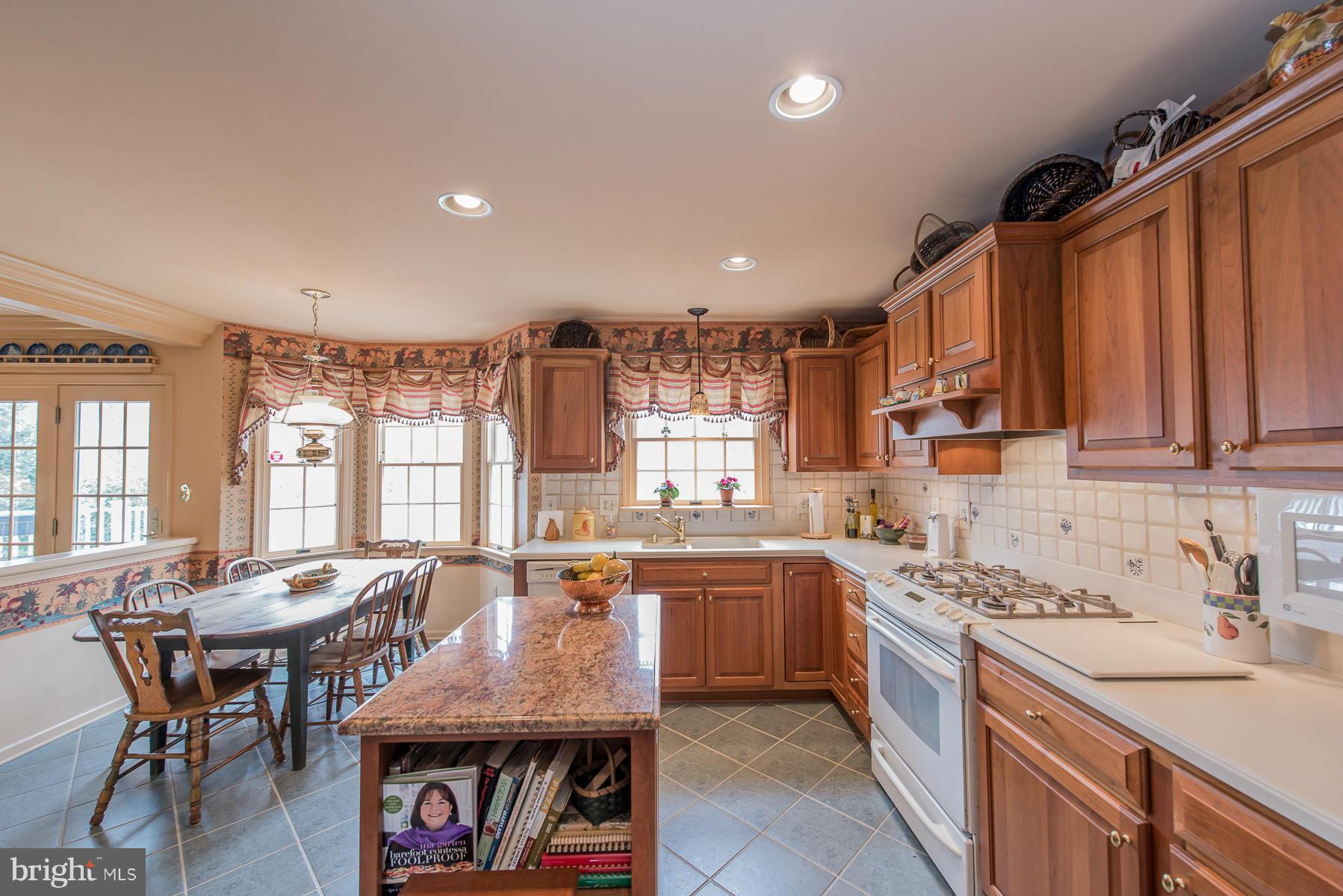 3677 Meadowvale Road Ellicott City, MD 21042 - Photo 13 of 30 a large kitchen with lots of counter space a sink and appliances