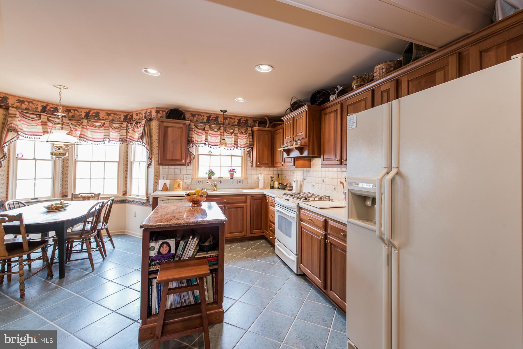 3677 Meadowvale Road Ellicott City, MD 21042 - Photo 14 of 30 a kitchen with stainless steel appliances granite countertop a sink and cabinets