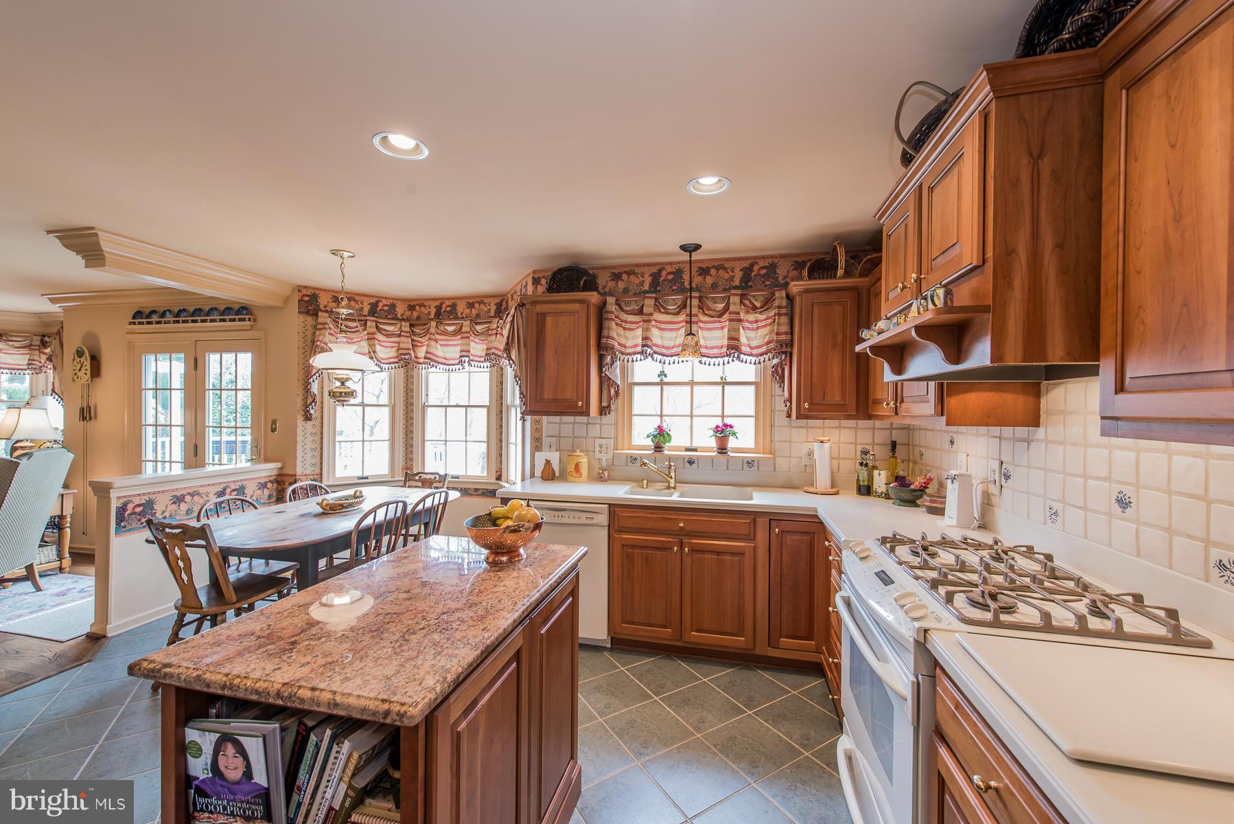 3677 Meadowvale Road Ellicott City, MD 21042 - Photo 3 of 30 a kitchen with a stove a sink dishwasher and a refrigerator