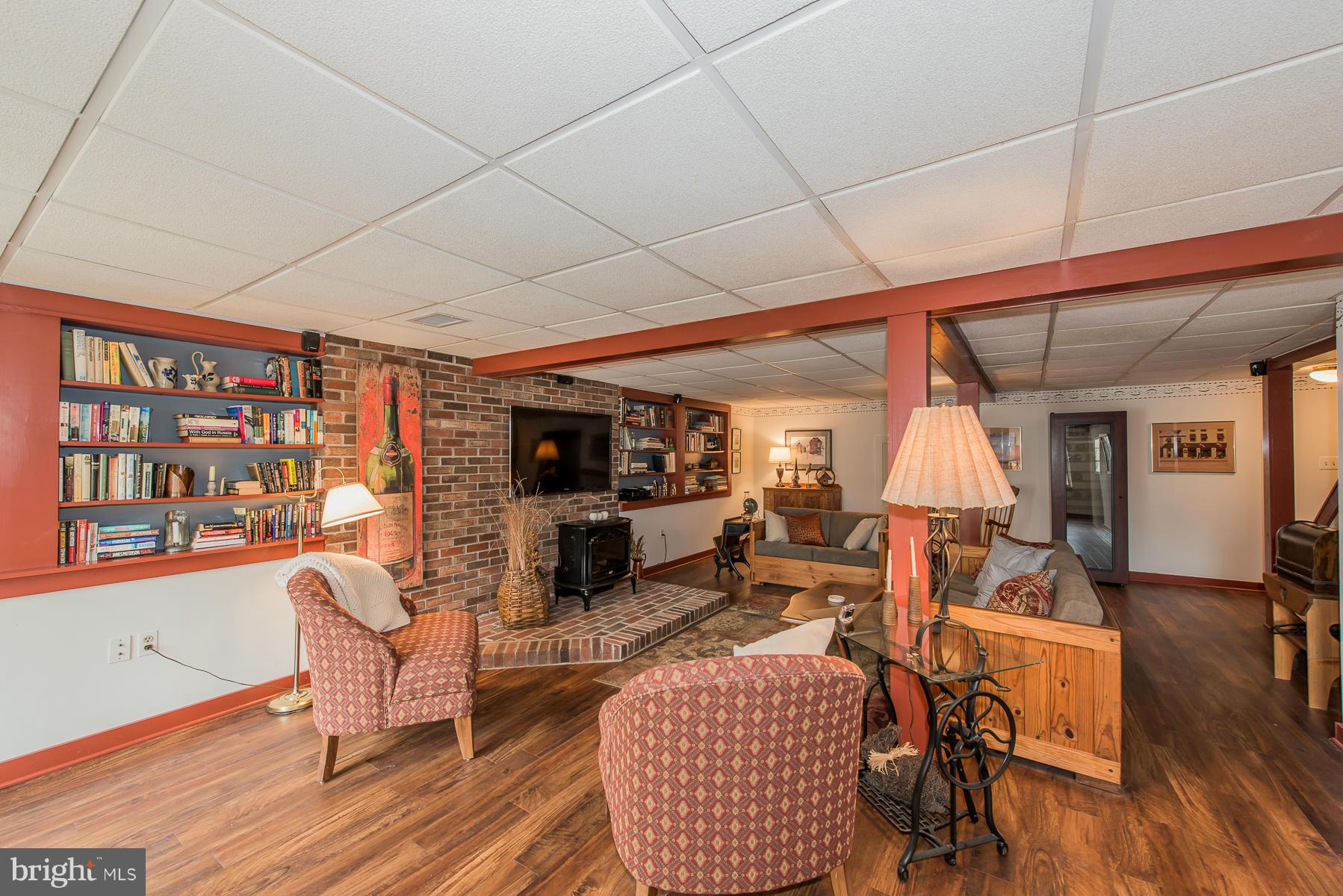 3677 Meadowvale Road Ellicott City, MD 21042 - Photo 22 of 30 a living room with furniture a flat screen tv and a table