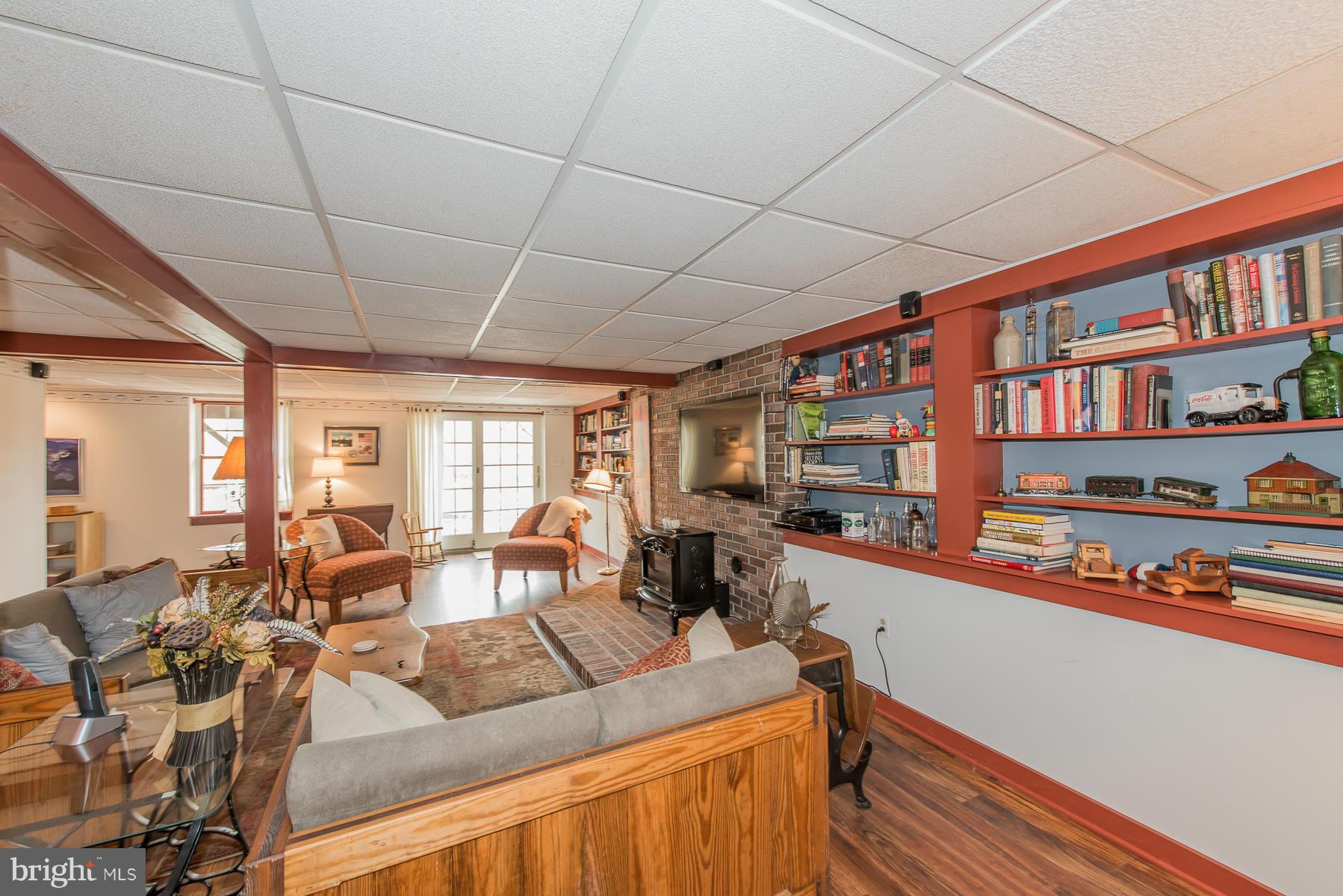 3677 Meadowvale Road Ellicott City, MD 21042 - Photo 23 of 30 a living room with furniture a bookshelf and a book shelf