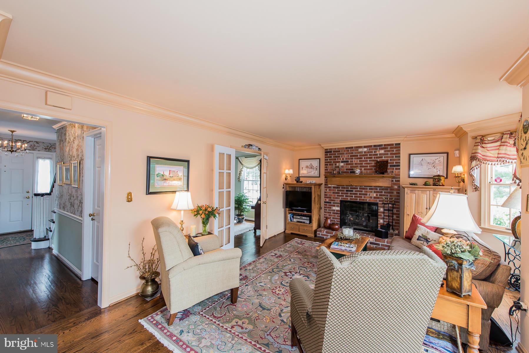 3677 Meadowvale Road Ellicott City, MD 21042 - Photo 7 of 30 a living room with furniture a fireplace and a flat screen tv