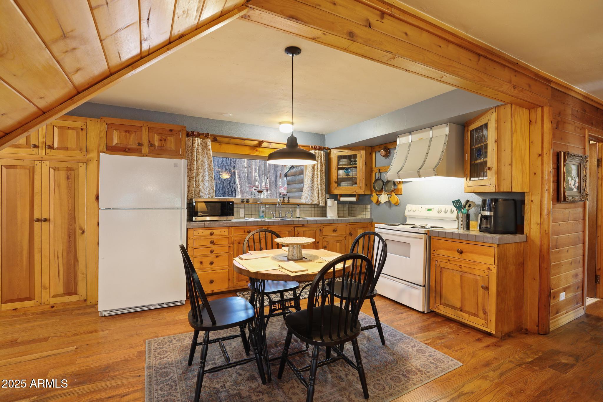 199 West Mockingbird Lane Payson, AZ 85541 - Photo 11 of 36 a dining table chairs and a refrigerator