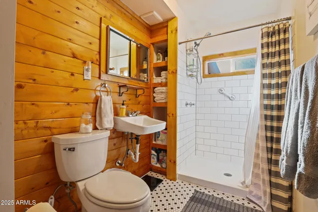 a bathroom with a toilet a sink and shower