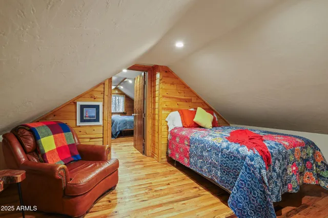 a bedroom with a bed couch and a window