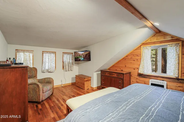 a bedroom with furniture and wooden floor