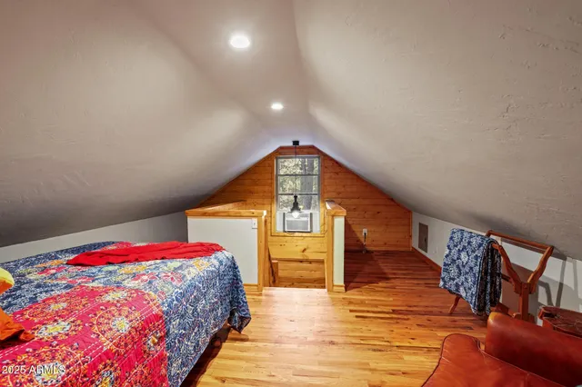 a view of bedroom with a bed and wooden floor