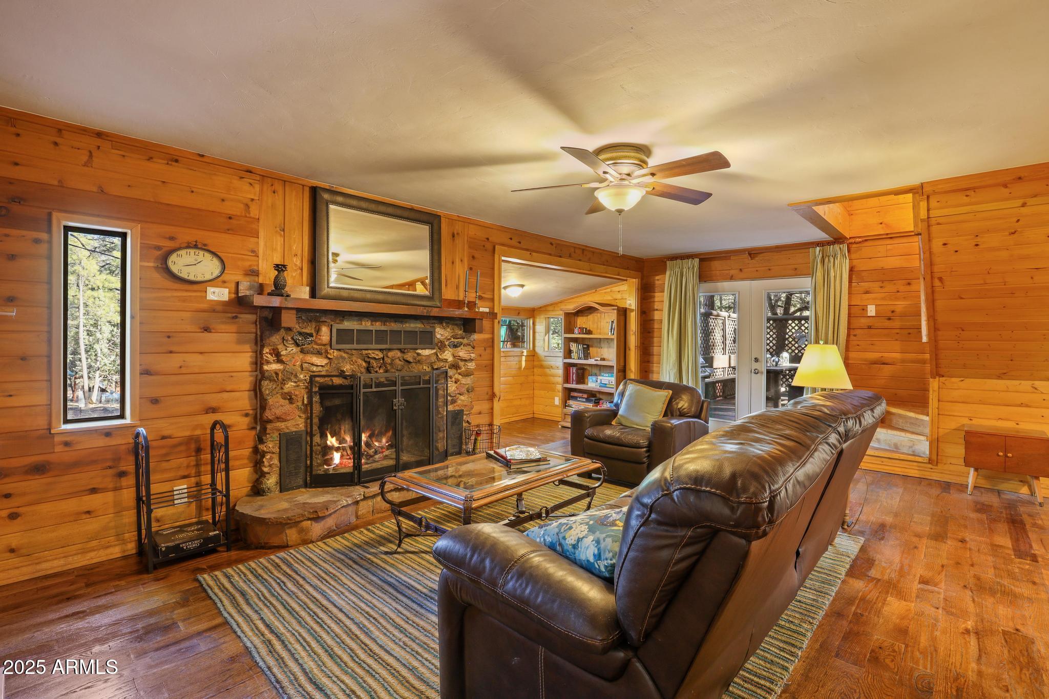 199 West Mockingbird Lane Payson, AZ 85541 - Photo 4 of 36 a living room with furniture a fireplace and a flat screen tv