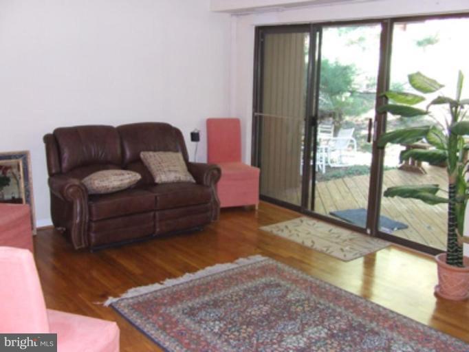 11186 Saffold Way Reston, VA 20190 - Photo 4 of 15 a living room with furniture and a floor to ceiling window