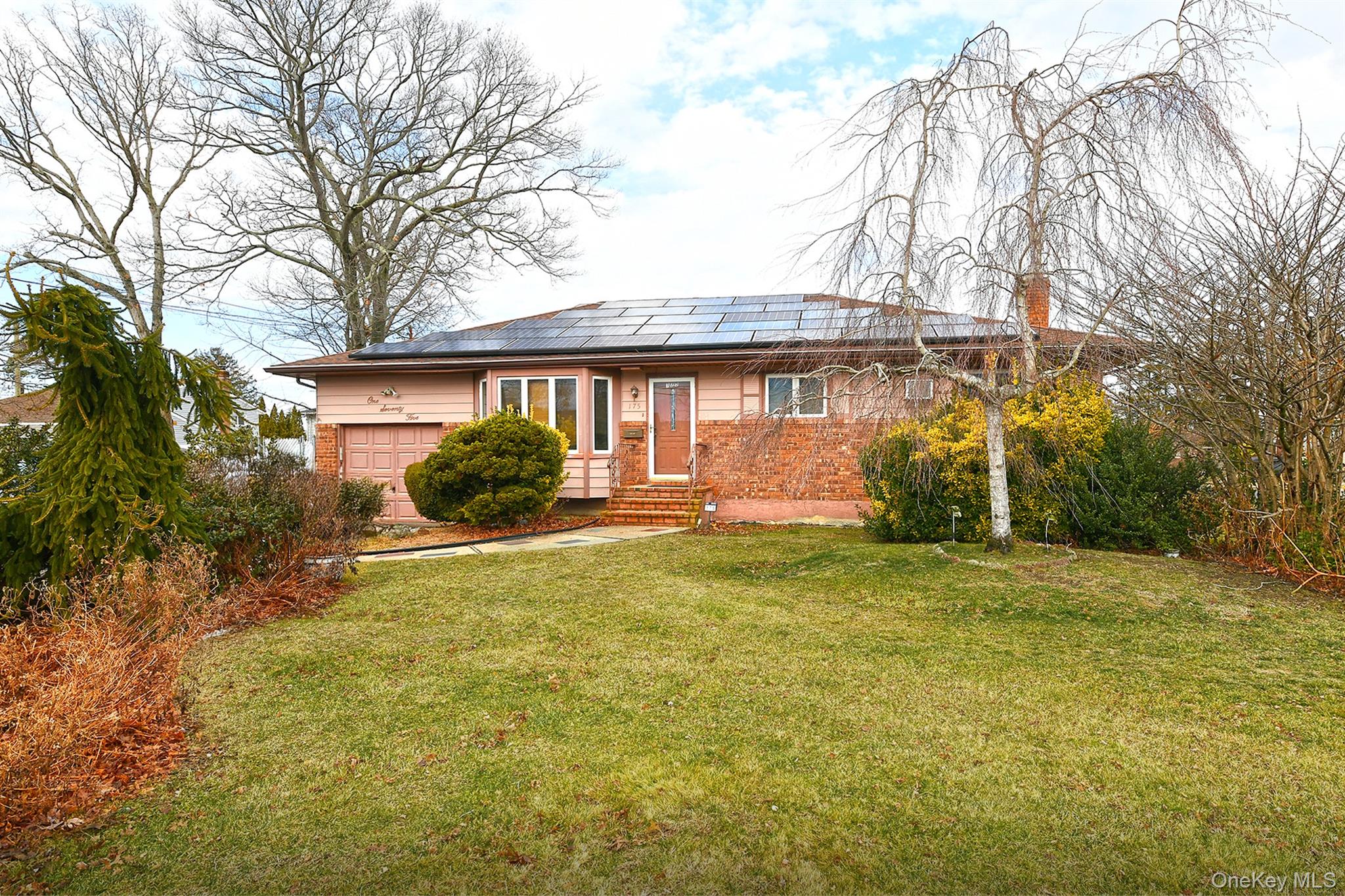 a front view of a house with garden