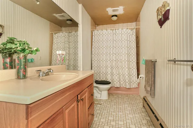 a living room with furniture and wall paintings