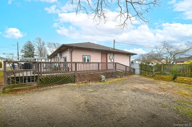 a view of an house with backyard and sitting area