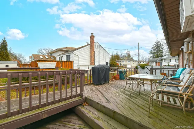 a view of a balcony with chairs and wooden floor