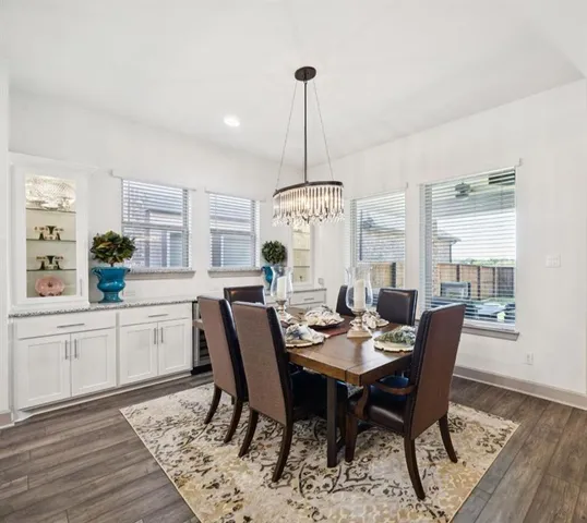 a view of a dining room with furniture window and wooden floor