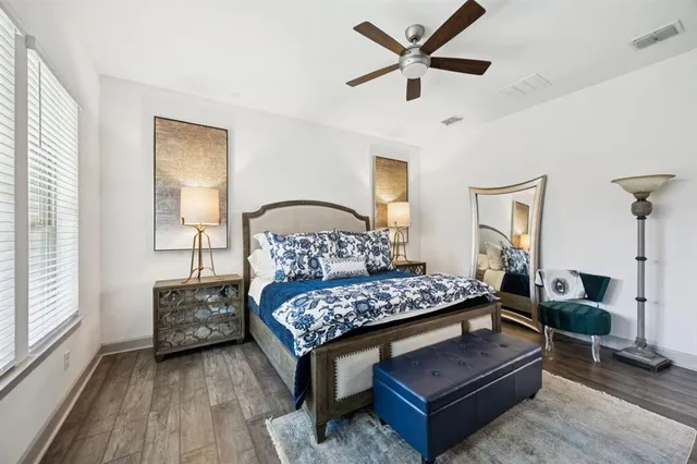 a bedroom with bed and wooden floor